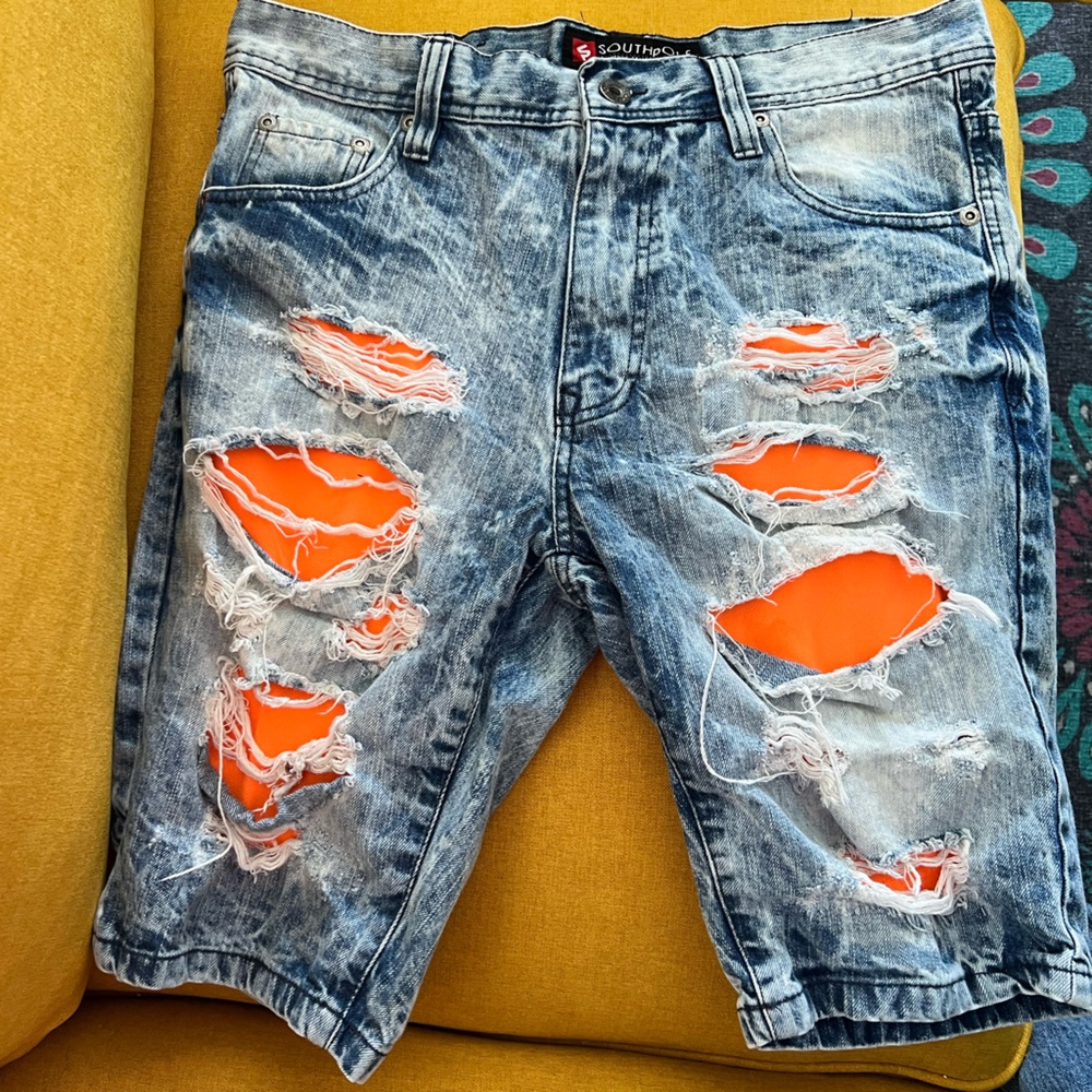 South Pole Men’s 34 distress acid wash shorts with orange underlays behind rips.